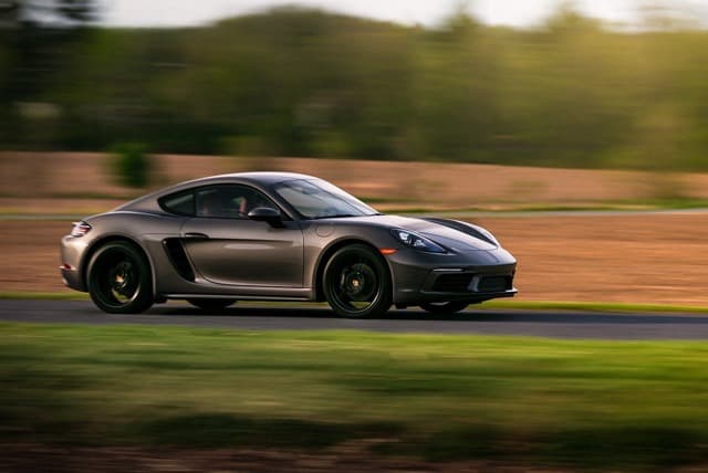 Gray sports car moving on a road